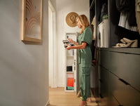 Lady Holding Jewelry Case in Closet