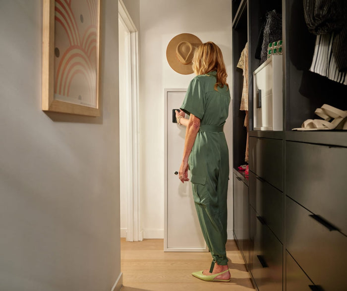 Lady Using Fingerprint Function on Floorsafe in Closet