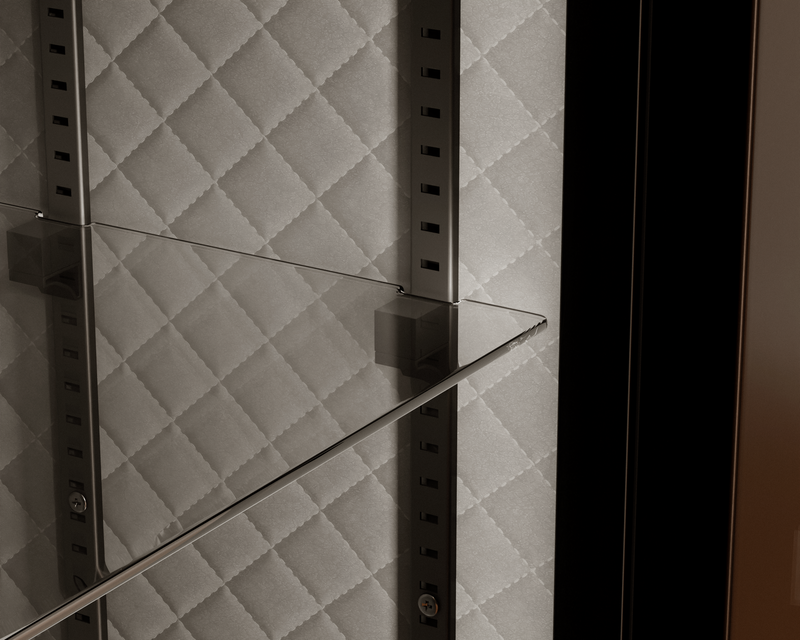 Mycube Glass in Onyx Black, close-up of a glass shelf on adjustable rails against quilted lining