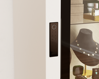 Mycube Glass in Mycube White, close-up of the biometric keypad beside jewelry on display