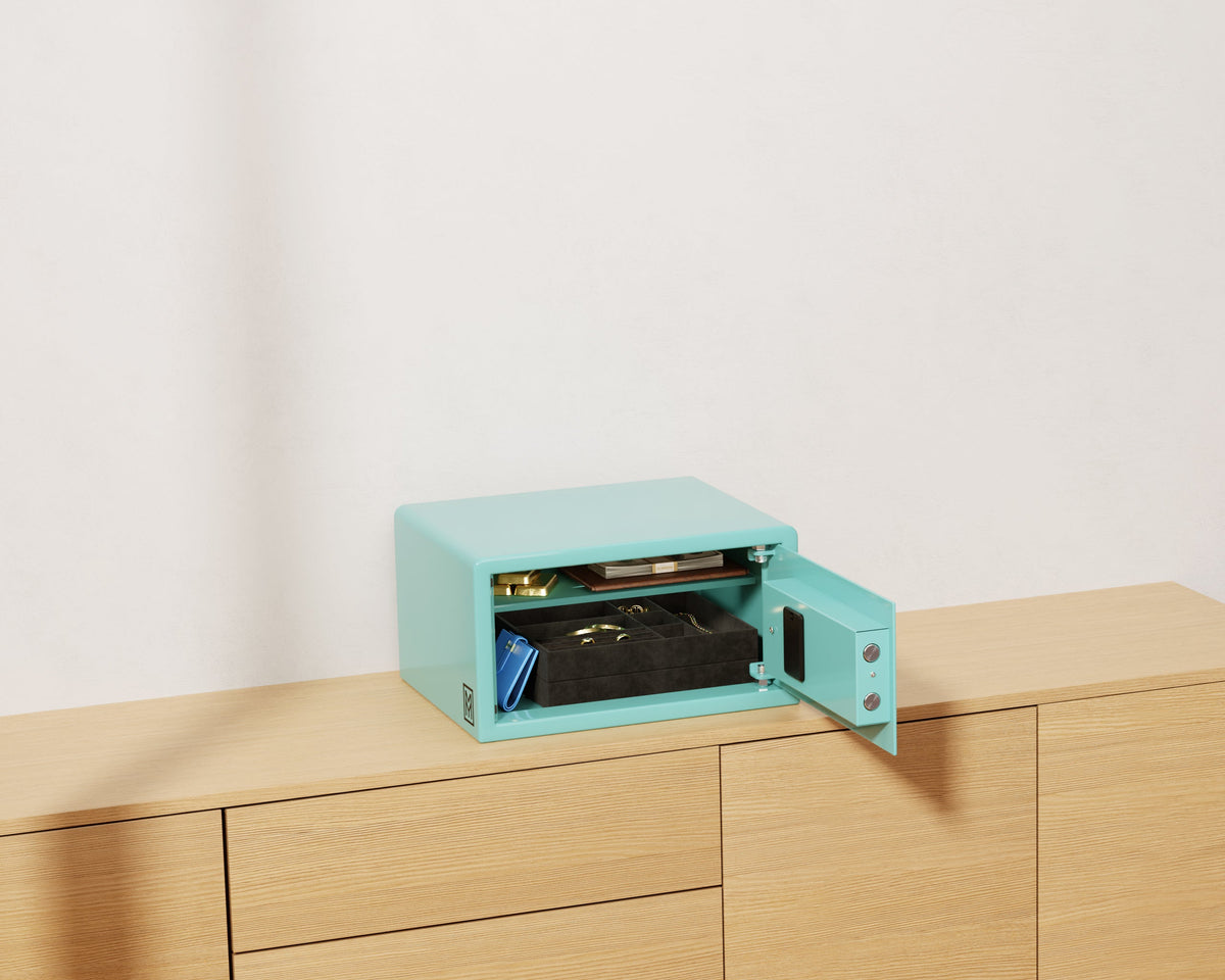 Mycube Mini safe in Robin's Egg Blue with biometric touchpad, three-quarter view with the door open