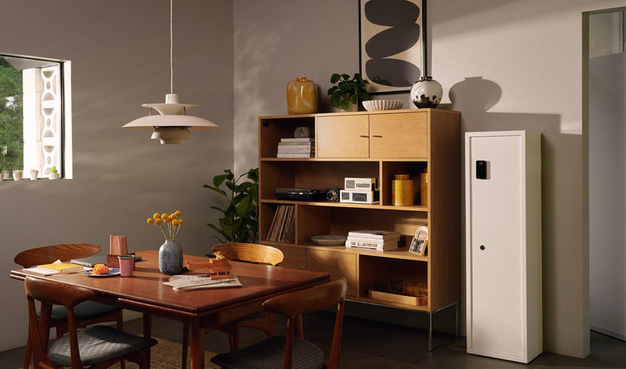 A Mycube floor safe beside oak shelving in a dining room