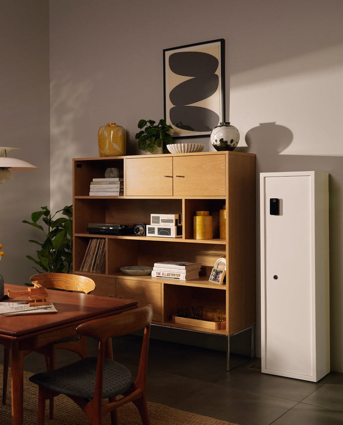 A Mycube floor safe beside oak shelving in a dining room