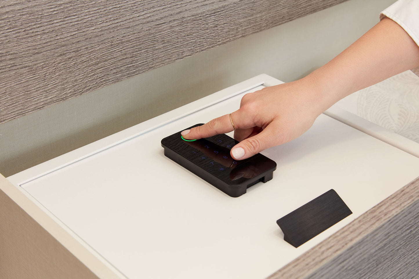 Person using biometric pad  on Biocube-In-Drawer white inside a drawer. 