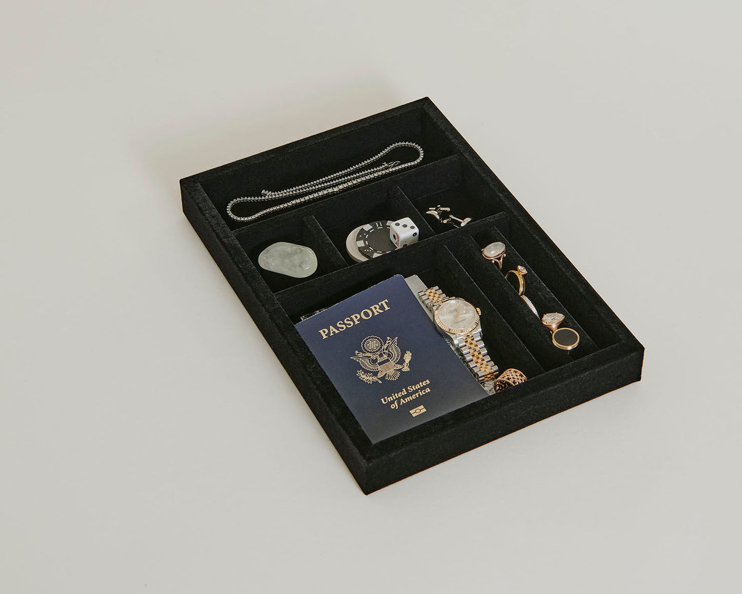 Black Fire Safe Tray with jewelry and a passport in it