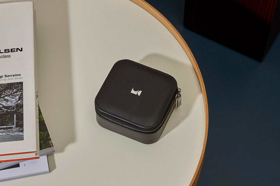 Black leather jewelry case sitting on a table