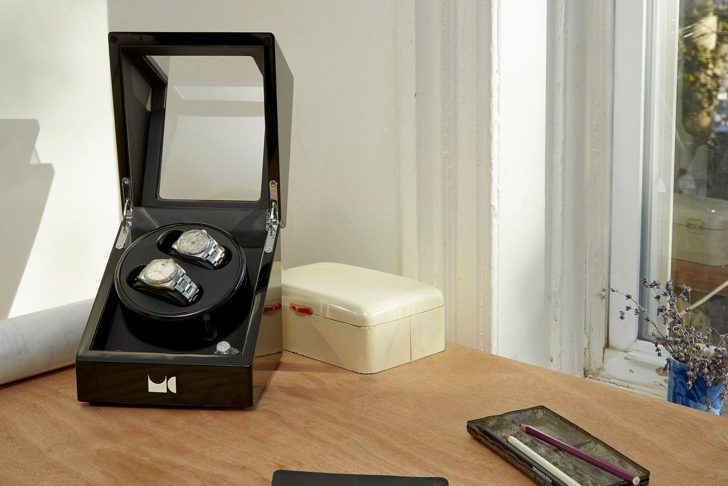 Watch winder with two watches on bedroom table